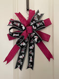 Large decorative bow for wreaths or door hangers comprised of a 2.5" Farrisilk hot pink pleated, metallic ribbon and a 2.5" black and white bunnies ribbon on a neutral background