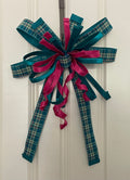 Large decorative bow for wreaths or door hangers comprised of a 2.5" d. stevens dark teal plaid ribbon, 1" dark teal velvet ribbon, and 1" fuchsia satin ribbon on a neutral background