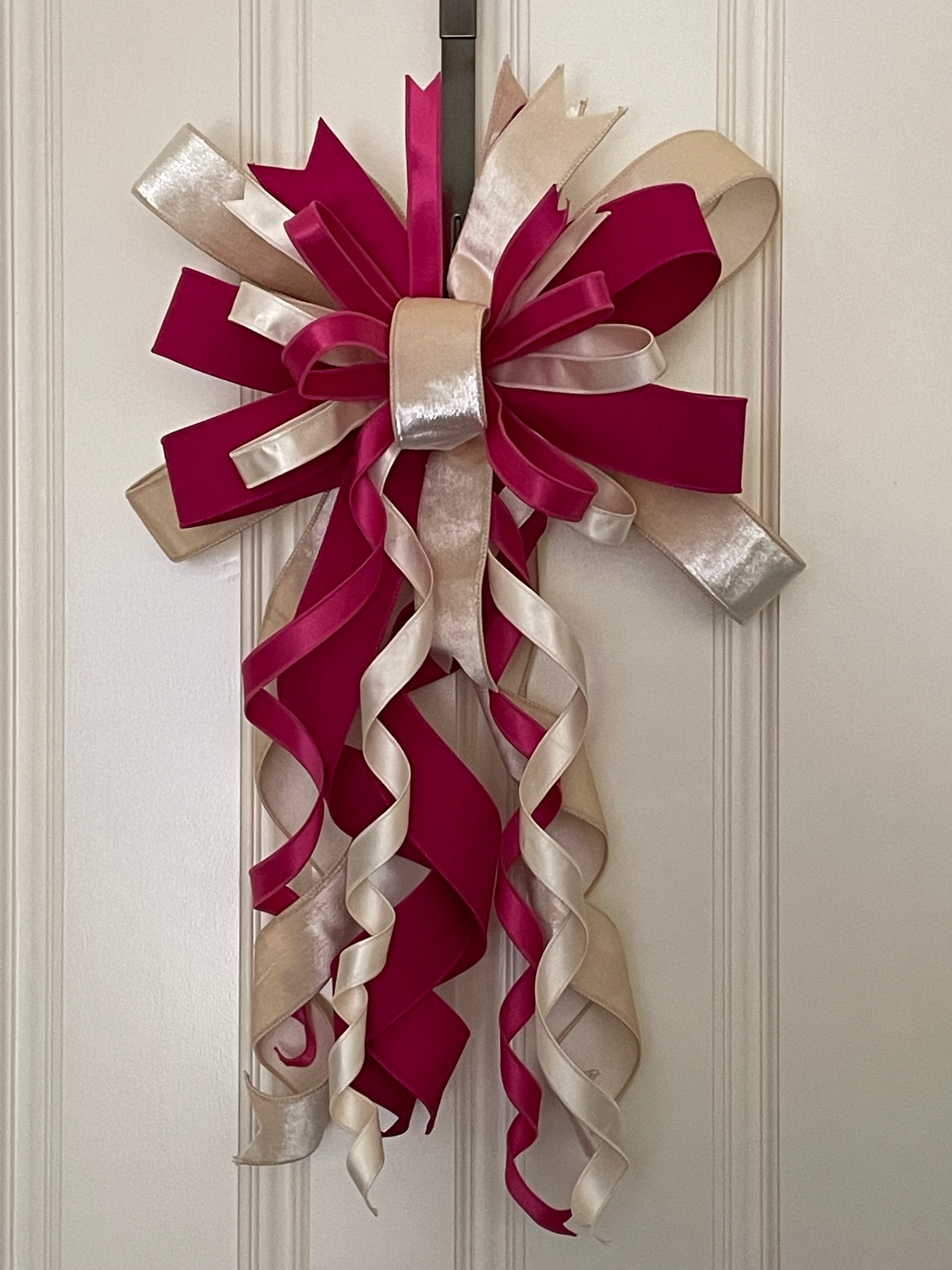 Large decorative bow for wreaths or door hangers comprised of a 2.5" Vickerman oat luster velvet ribbon, a 1" Farrisilk fuschia dupion ribbon, a 1" fuschia satin ribbon, and a 1" oat satin ribbon on a neutral background