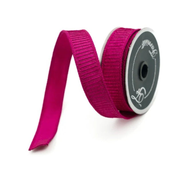 A roll of 1" pleated hot pink metallic ribbon with the Farrisilk logo shown on the roll's flange on a neutral background